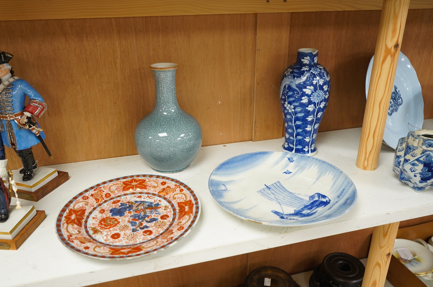 Two Chinese porcelain vases including a crackle glaze example and two plates, largest 23cm high. Condition - poor to fair